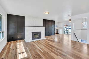 Unfurnished living room featuring light wood finished floors and a fireplace