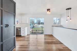 Unfurnished dining area with light wood-style flooring and baseboards