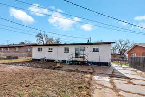 Back of property featuring a gate and brick siding