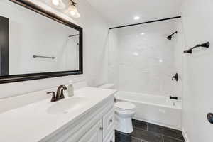 Bathroom featuring shower / bathtub combination, vanity, and recessed lighting