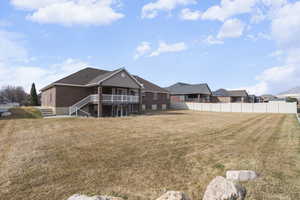 Rear view of house featuring brick siding and stairway