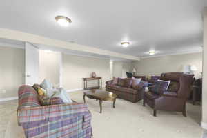 Living room featuring light carpet and ornamental molding