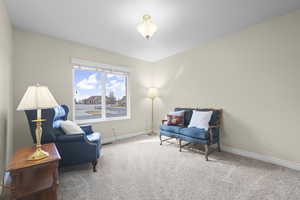 Sitting room with carpet flooring and baseboards