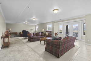 Living room with ornamental molding and light tile patterned floors