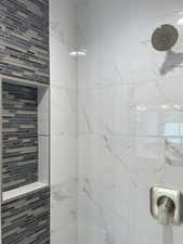 Bathroom featuring a tile shower