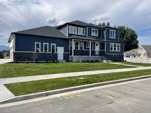 Prairie-style house featuring board and batten siding, stone siding, and a shingled roof