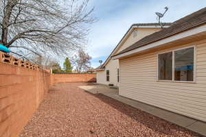 Fenced backyard with a patio area
