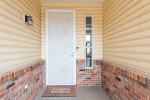 Property entrance with covered porch