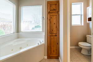 Bathroom featuring a whirlpool tub and light tile patterned flooring