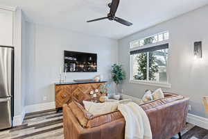 Living room featuring wood finished floors and ceiling fan