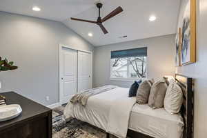 Bedroom with vaulted ceiling, recessed lighting, ceiling fan, wood finished floors, and a closet