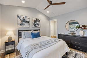 Bedroom with lofted ceiling, light wood-style floors, recessed lighting, and ceiling fan