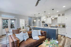 Living room featuring light wood-type flooring, recessed lighting, and french doors