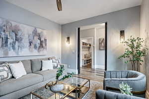 Living room with wood finished floors and ceiling fan