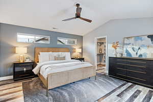 Bedroom featuring light wood finished floors, a ceiling fan, and a spacious closet