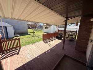 Wooden deck featuring a shed