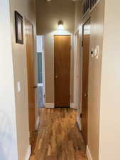 Corridor featuring wood finished floors and baseboards