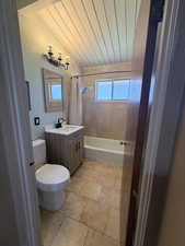 Bathroom featuring vanity, shower / tub combo with curtain, wooden ceiling, and light tile patterned floors