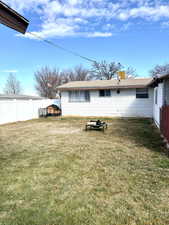Back of house featuring a chimney