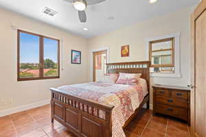 Tiled bedroom with ceiling fan and recessed lighting