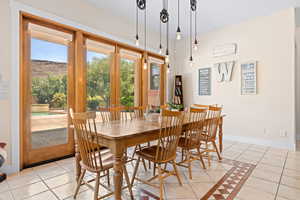 Dining area with light tile patterned flooring and inlaid floor details