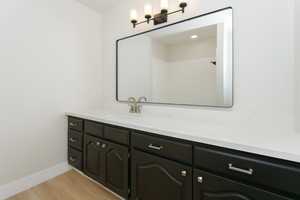 Bathroom with vanity and light wood-type flooring