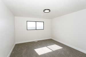 Spare room with carpet flooring and a textured ceiling