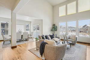 Living room with light wood finished floors and a high ceiling