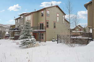 View of snow covered back of property