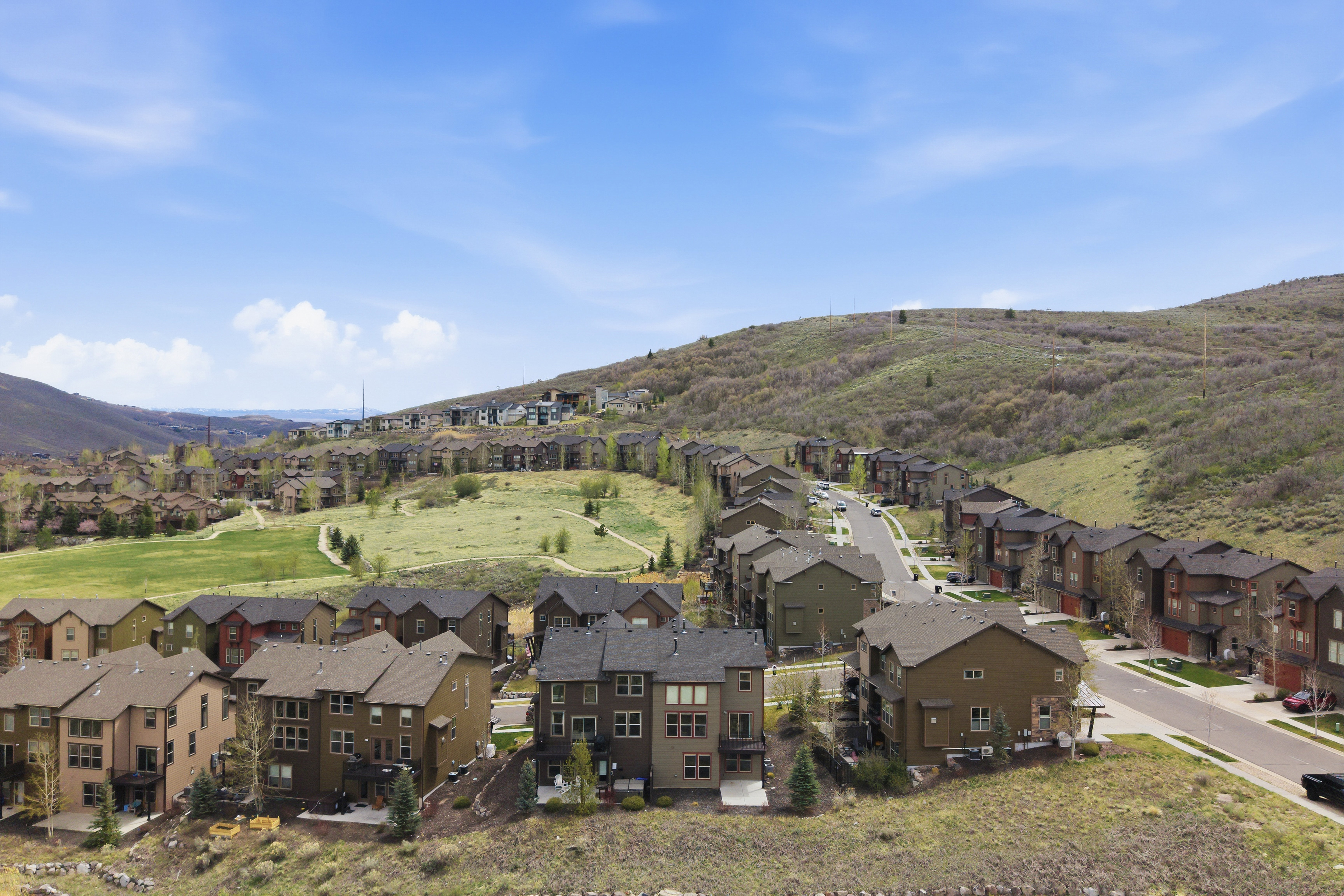 Modern residential development featuring multi-story homes with varied exterior finishes