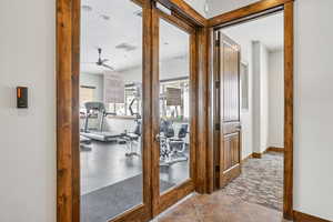 Hall with dark carpet and baseboards