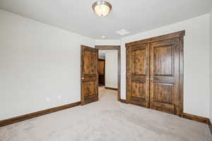 Unfurnished bedroom featuring carpet floors and a closet