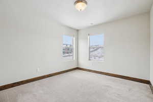 Spare room with carpet flooring and baseboards