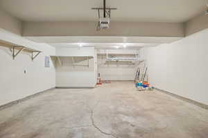 Garage with electric panel and a garage door opener