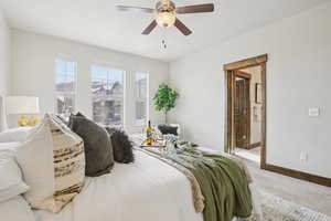 Carpeted bedroom with a ceiling fan and ensuite bath