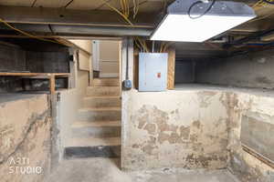 Unfinished basement with electric panel