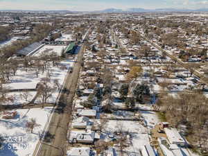Snowy aerial view featuring a residential view and a mountain view