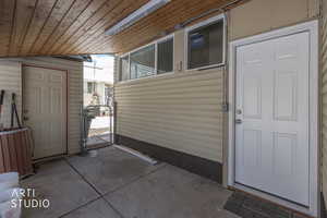 Property entrance featuring a patio area and a gate