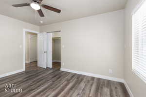 Unfurnished bedroom featuring dark wood-style floors, a closet, ceiling fan, and a textured ceiling
