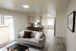 Living area with light wood-style floors and baseboards