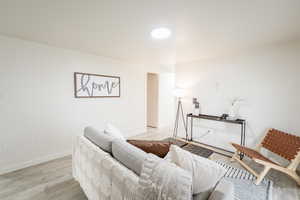 Living room with wood finished floors and baseboards