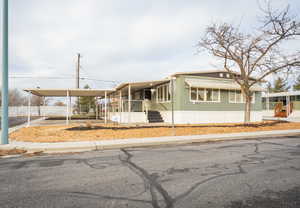 Manufactured / mobile home featuring an attached carport