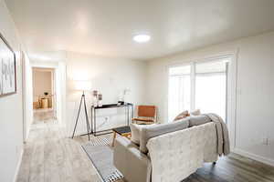 Living area with light wood-style flooring and baseboards