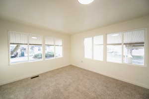 Unfurnished room featuring baseboards and carpet floors