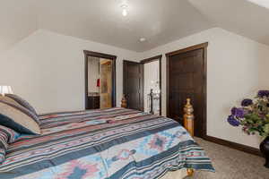 Bedroom with carpet floors and ensuite bathroom