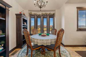 Dining room featuring stone tile flooring, suspended lighting, healthy amount of natural light, and a mountain view
