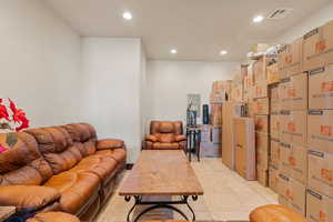 Living room featuring recessed lighting and light tile patterned flooring