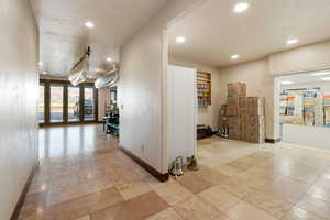 Hall with baseboards and recessed lighting
