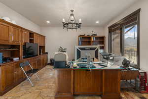 Office with stone tile flooring and hanging lights