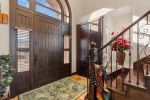Entrance foyer featuring stairs and baseboards